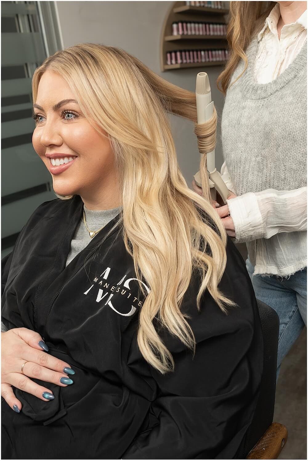 Seattle stylist Carrie Albertus at Mane Suite hair styling with extensions for a blonde client